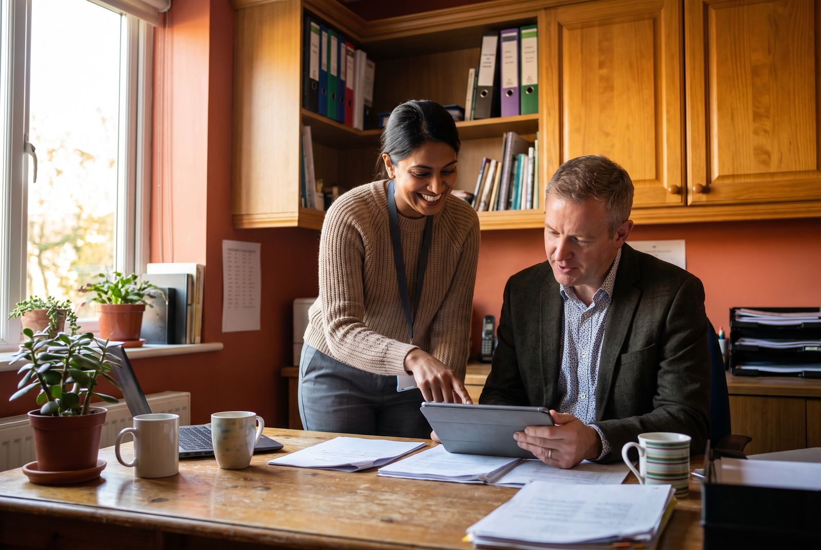 A care home manager and a council officer reviewing bookings together